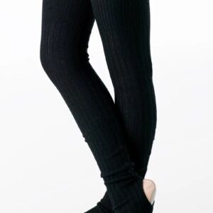 A dancer wearing pale pink tights and shoes stands with crossed legs, showcasing Adult Tall Leg Warmers in black ribbed knit that cover her legs from thigh to ankle.