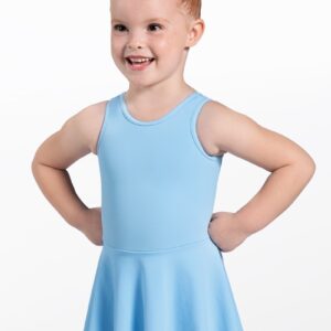 A young girl with red hair in a bun wears the Blue Kids ClassicTank Dress and smiles with her hands on her hips, standing against a plain white background.