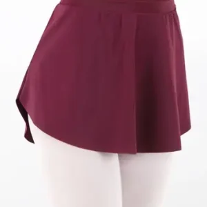A person wearing the Balera High-Low Skirt in burgundy over white tights and a matching leotard, shown from the waist down against a plain white background.