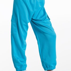 A person is shown from the waist down wearing Weissman Parachute Pants in bright blue, featuring an elastic waistband, cuffs, and side pockets, paired with white sneakers against a plain white background.