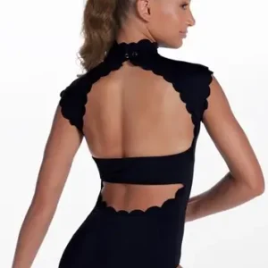 A young woman with light brown hair in a ponytail models the Scallop Trim Mock Neck Leotard, featuring scalloped edges and open back cutouts, as she poses with one arm bent and looks to the side against a white background.